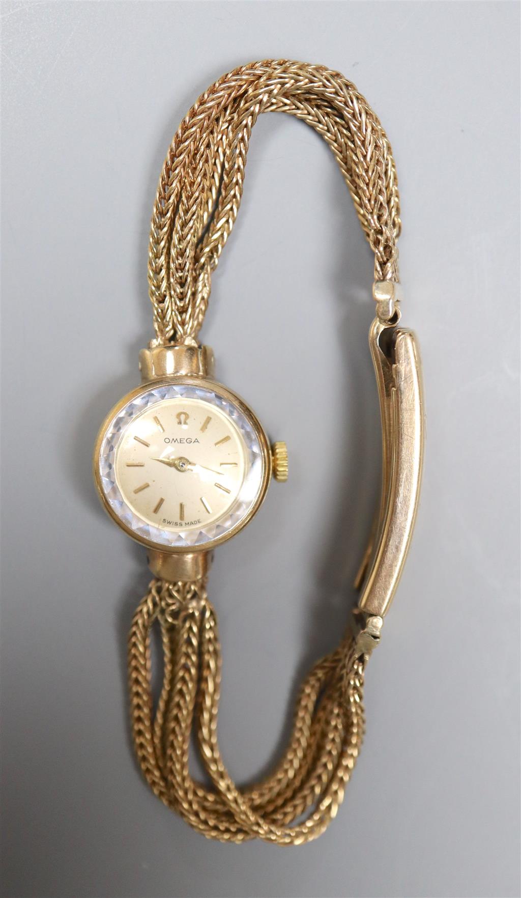 A ladys 1960s 9ct gold Omega manual wind wrist watch, on multi strand bracelet with expanding clasp,